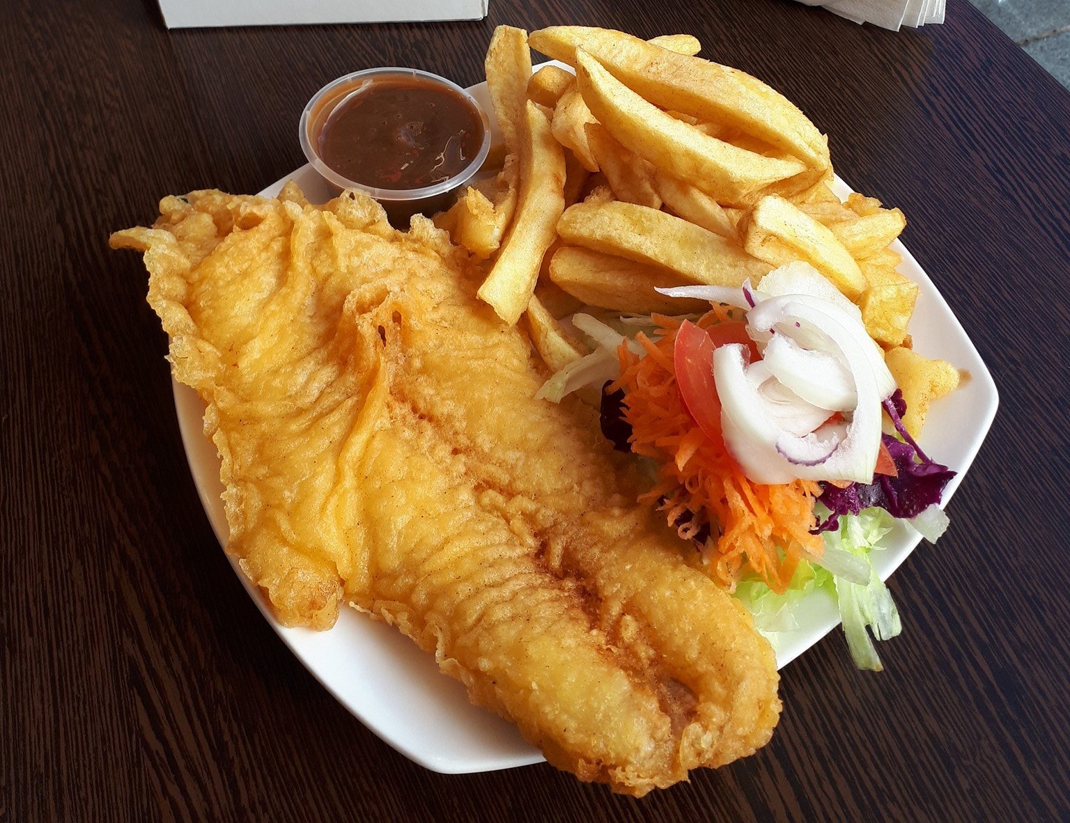 fish n chips served with sauce & salad at Glorias Fast Food in Bonnyrigg